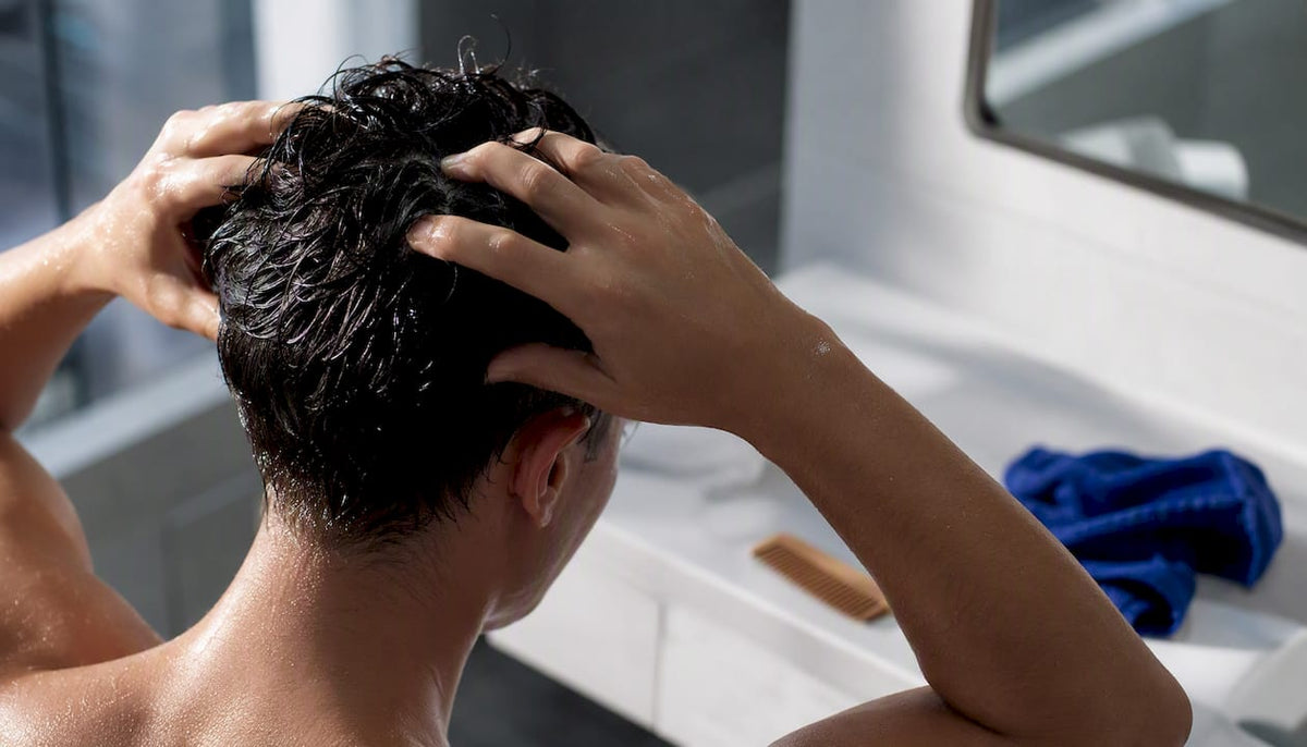 Hands gently performing a scalp massage