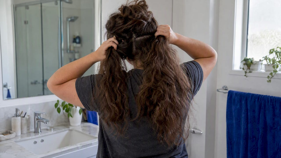 Woman sectioning thick hair before wash day